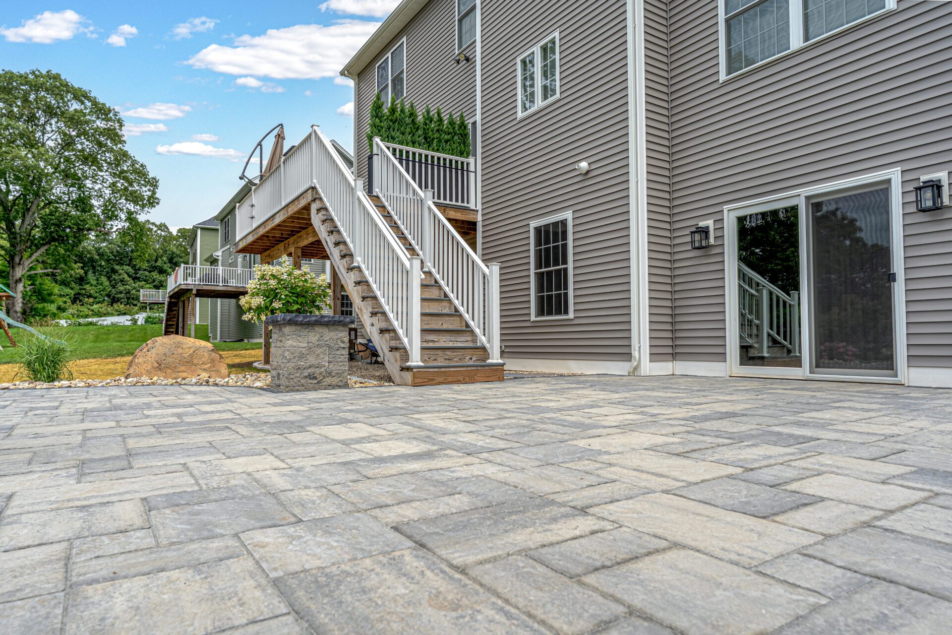 Newly installed paver patio with stone accents and landscaping by HQ Landscaping in Southington, Connecticut