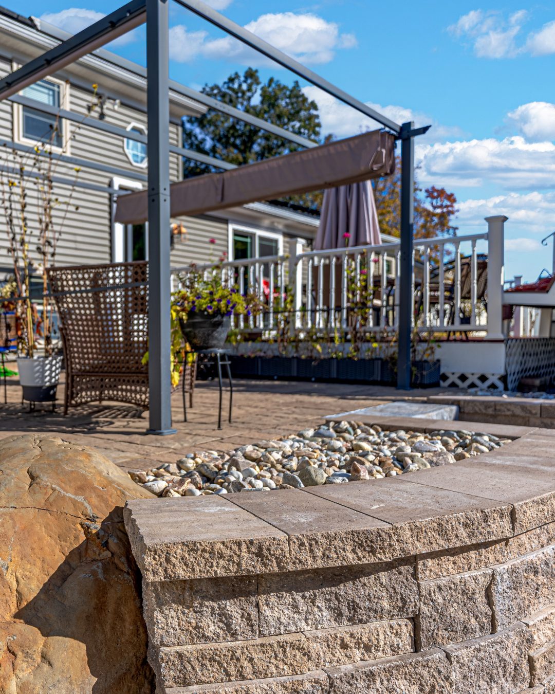 ChatGPT said:</p>
<p>Patio retaining wall with stone cap and decorative river rock in a Berlin CT backyard. Modern outdoor seating area and pergola structure in the background.